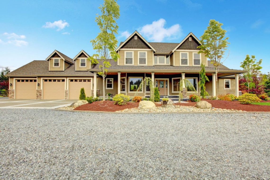 brown home front exterior with three single car garages and two stories