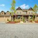 brown home front exterior with three single car garages and two stories