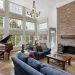 living room with blue sofas piano and fireplace