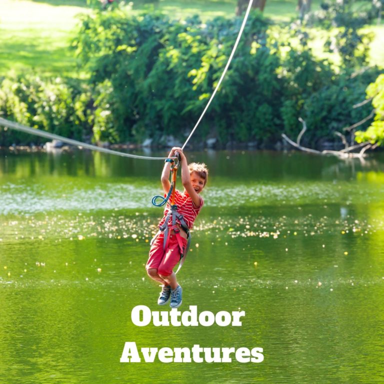 small child in red clothing zipline-ing over water