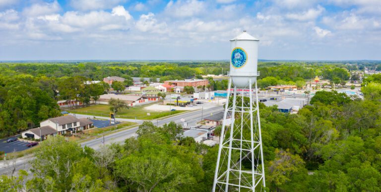 An aerial drone view of Crystal River, Florida with a water town and town in the background.