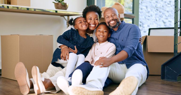Moving, portrait and happy black family in home with boxes and hug in living room together.